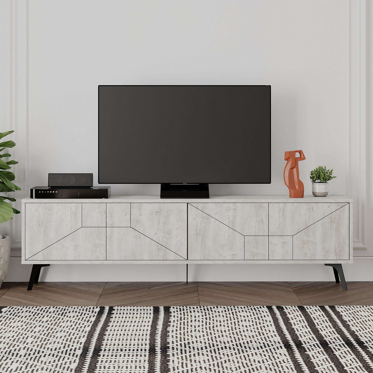 Anthracite grey TV stand with geometric panel doors, long console base, and slim legs