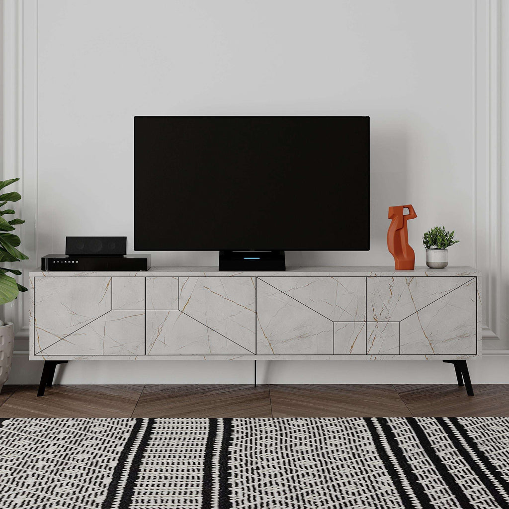 White modern TV stand with open shelves, geometric cabinet fronts, black TV on top.