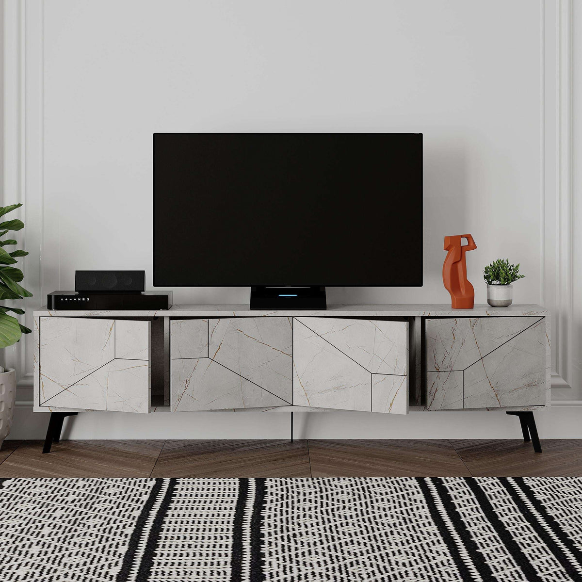 White TV stand with three open media sections and cabinet doors, black TV on top.