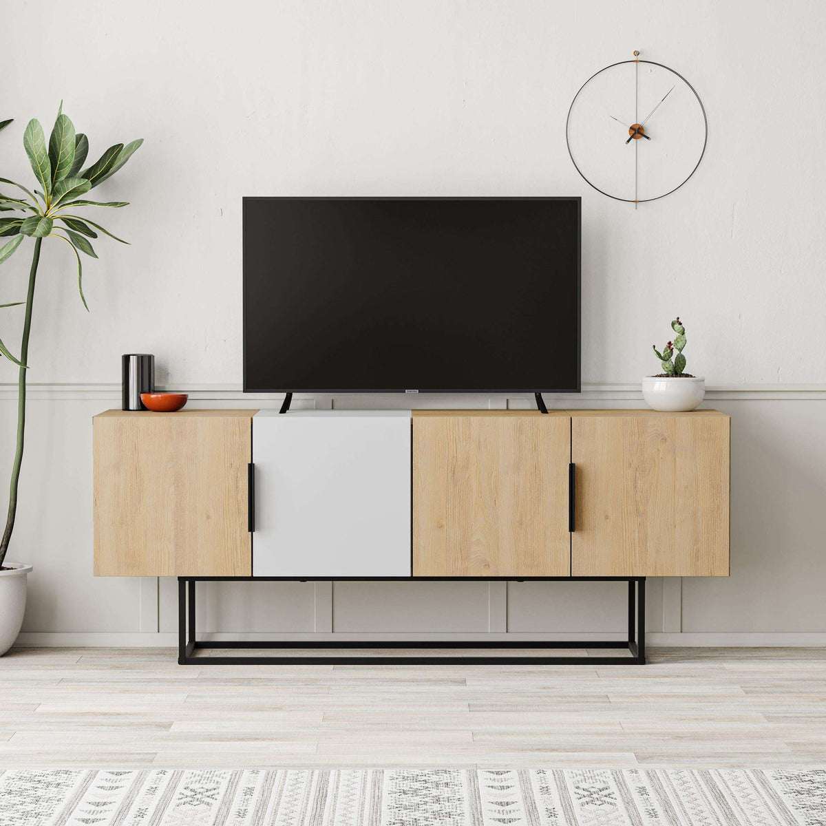 Modern TV stand with oak-look wood, white cabinet doors, dark flat-screen TV, black frame