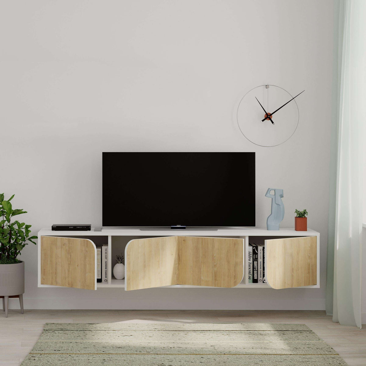 Floating TV stand with black TV shelf and light oak doors across open media storage.