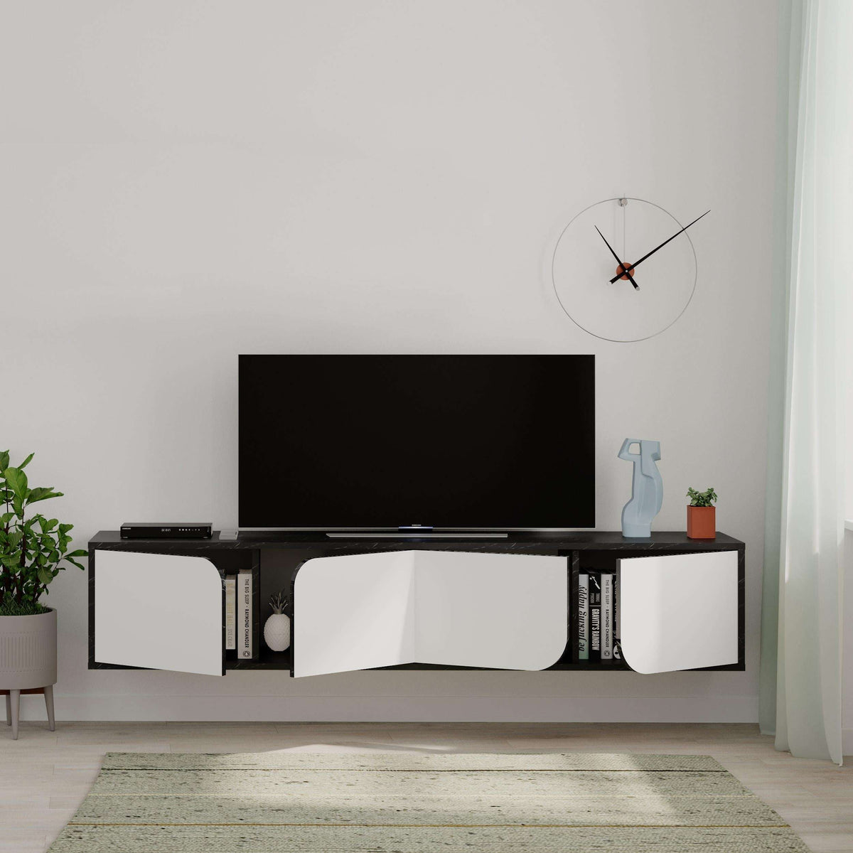 Floating TV stand with dark top and three white drawer fronts, curved center cutout