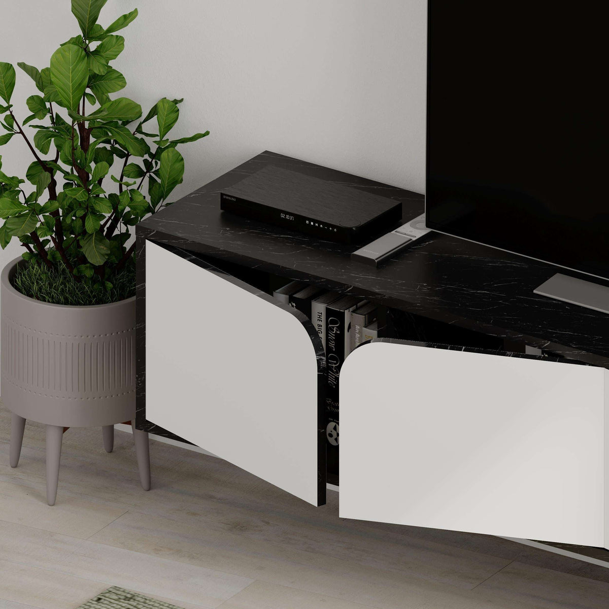 Floating TV stand with dark top and white cabinet drawers, open shelf for books