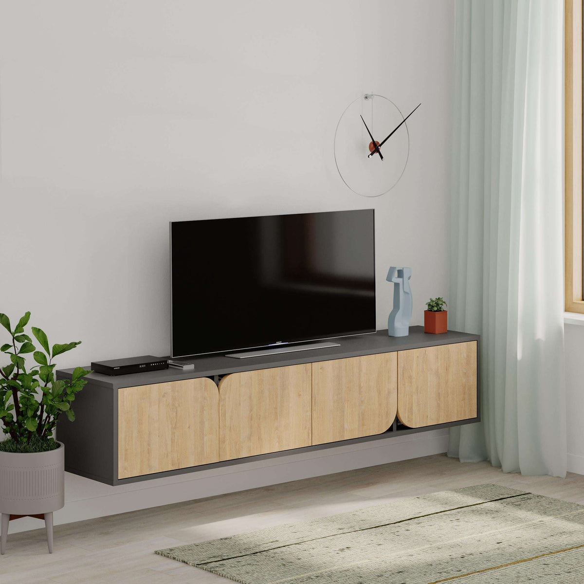Floating TV stand with black top and light oak cabinet doors with curved center