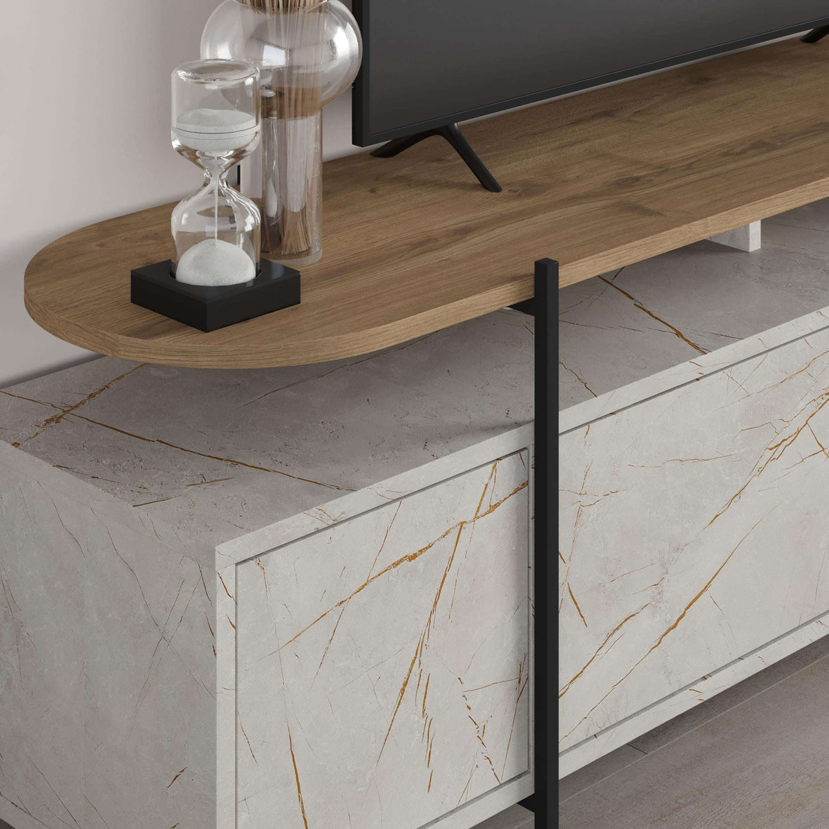 Close-up of TV stand storage: black marble-effect drawer fronts with rounded wood top.