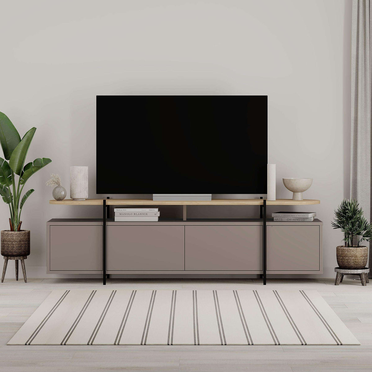 Modern TV stand with matte gray cabinet doors, open center shelf, and slim metal legs