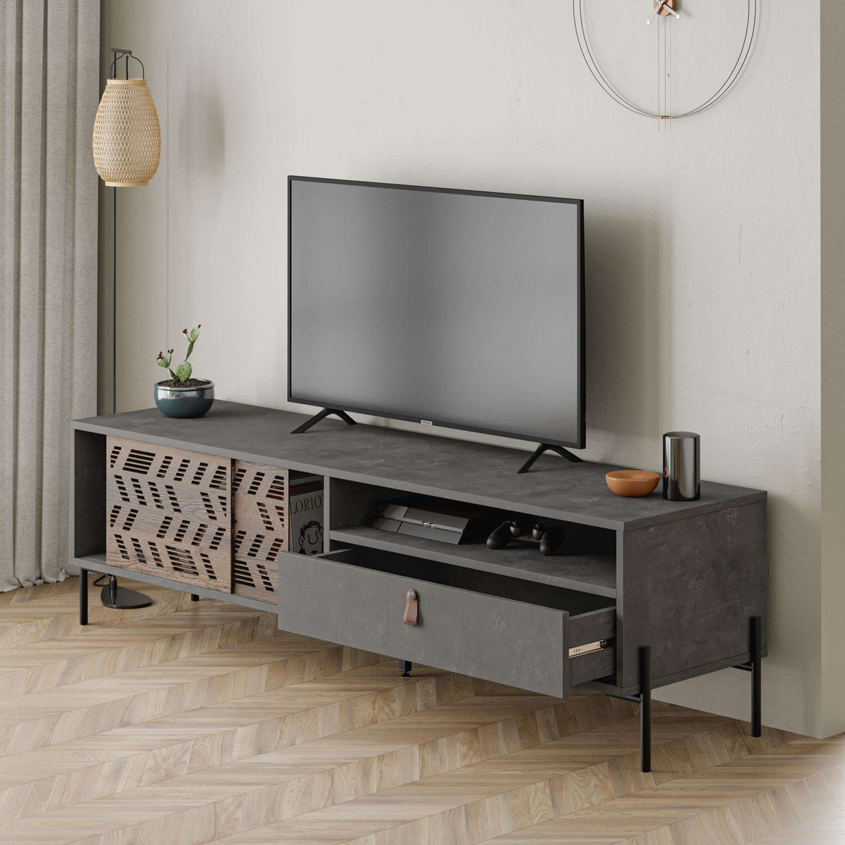 Modern TV stand in dark grey with open shelf for media and a central drawer