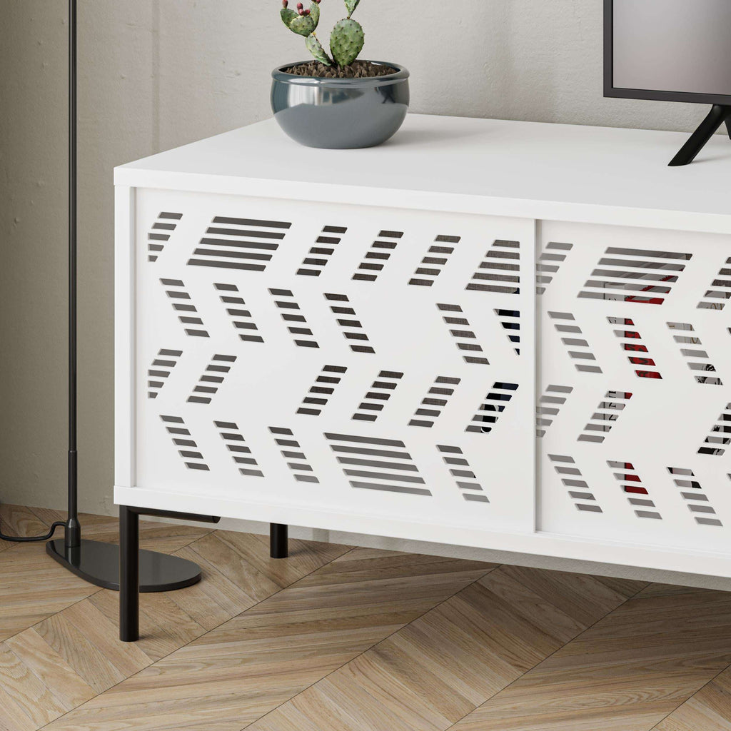White storage cabinet detail with geometric perforated doors and drawer