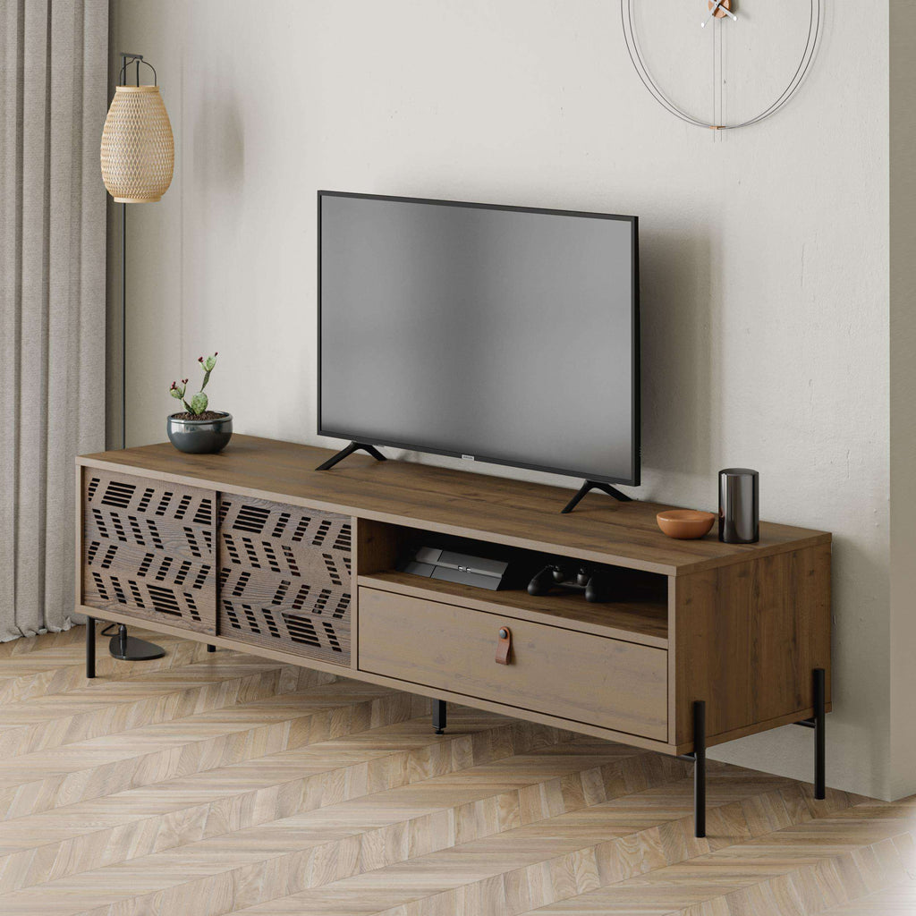 Modern TV stand with patterned cabinet panels, central drawer, and media shelf