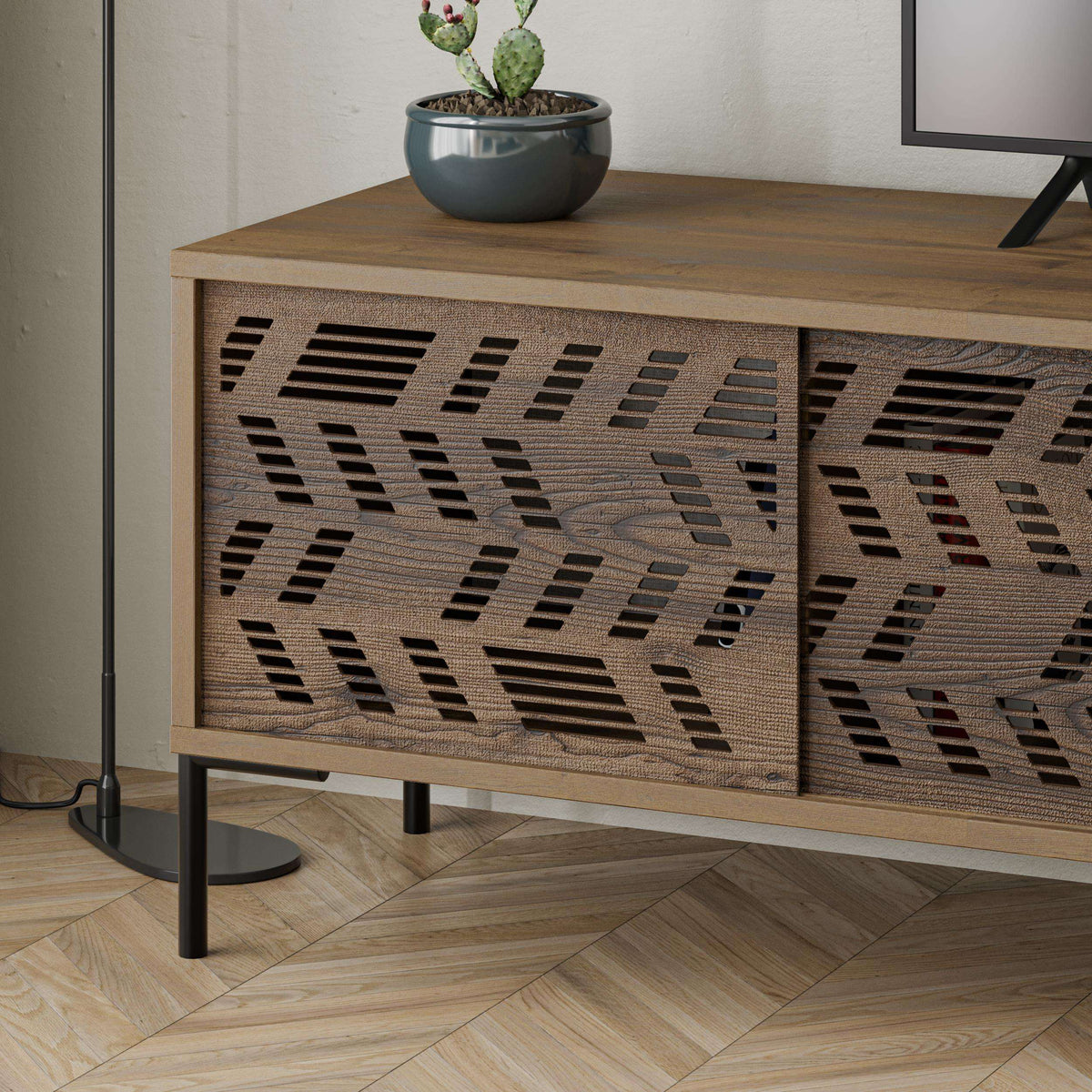 Close-up of patterned cabinet door on modern TV stand with wood frame