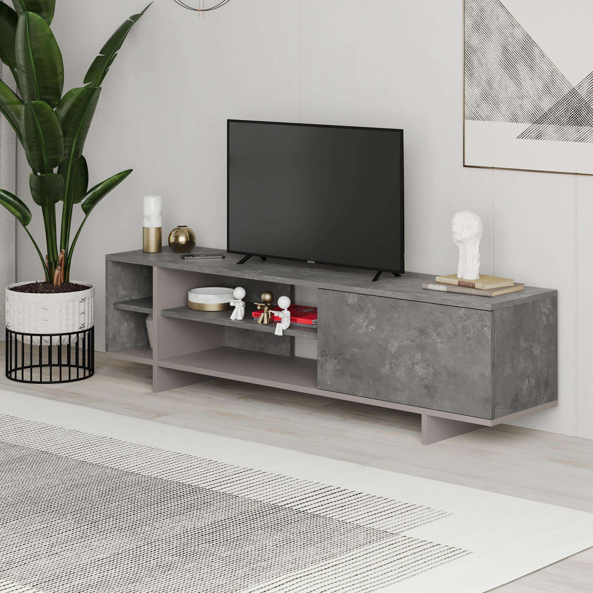 Grey TV stand with open shelving and long cabinet drawer, concrete-look finish.