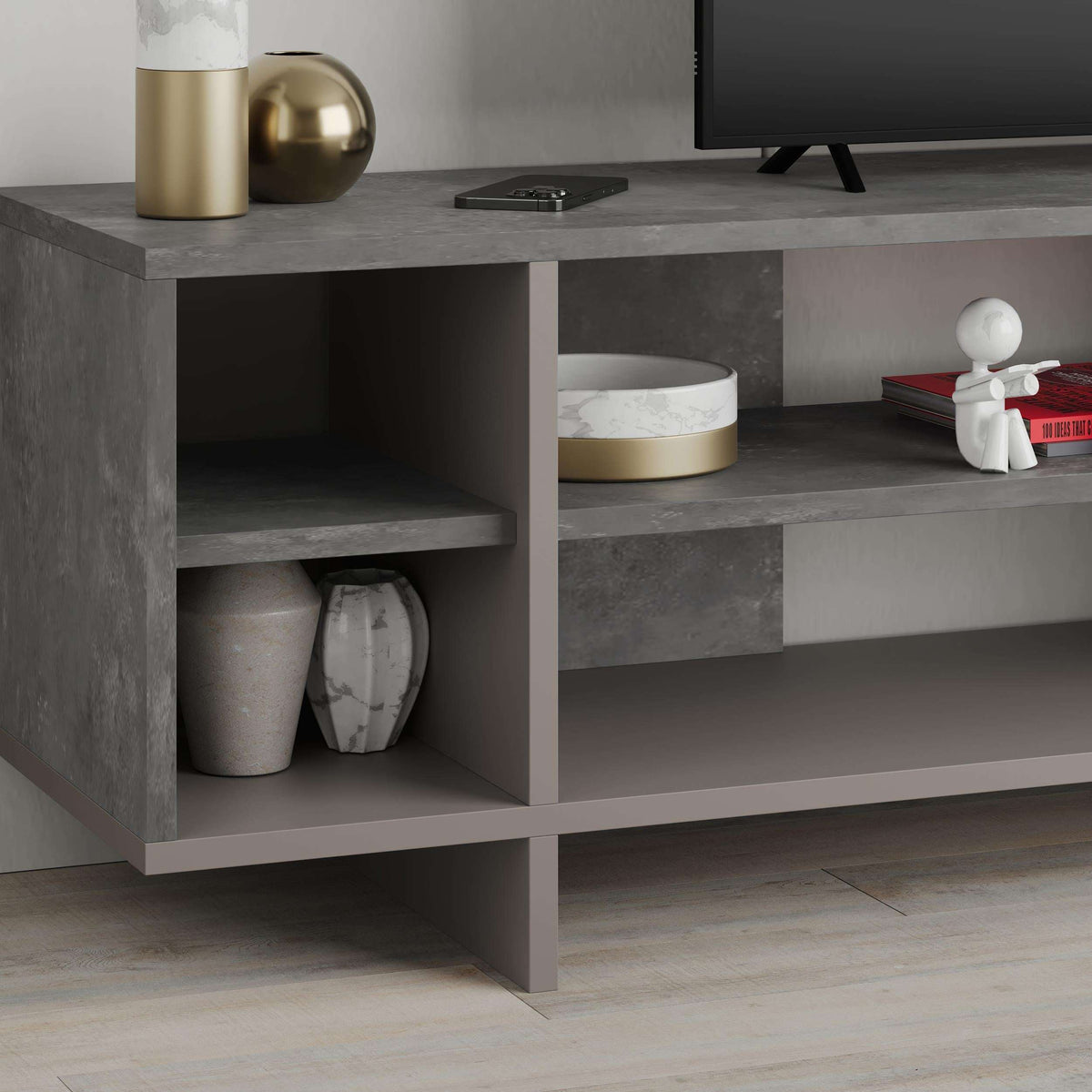 Concrete-look TV stand with open shelves and storage cubbies, dark grey frame.