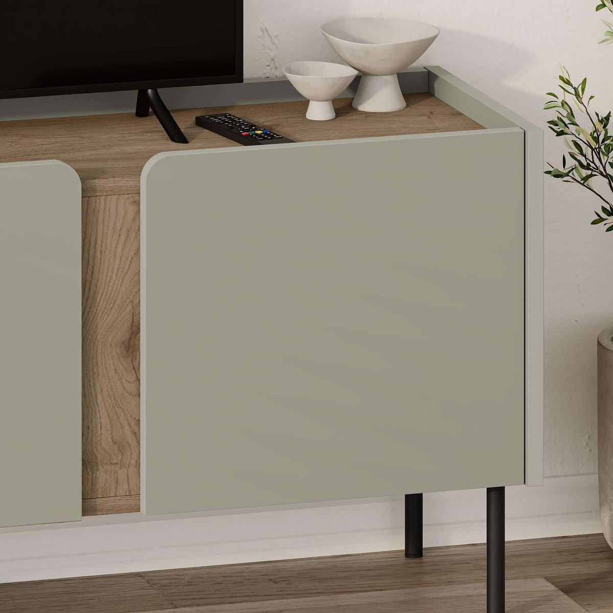 Close-up of light sage front panel on a natural wood TV unit cabinet