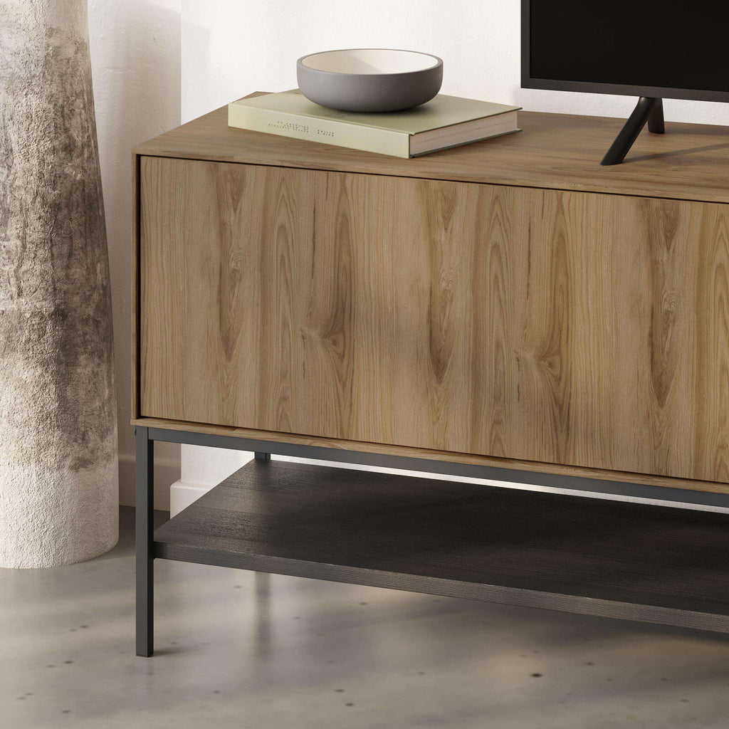 Side view of light wood TV stand with open lower shelf and cabinet front