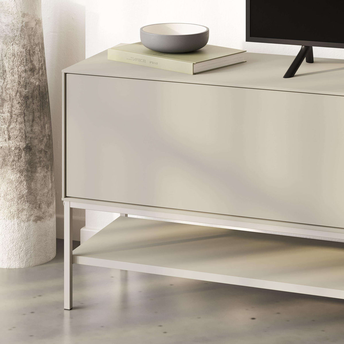 Amira TV unit close-up in sandstone with open lower shelf and slim metal legs