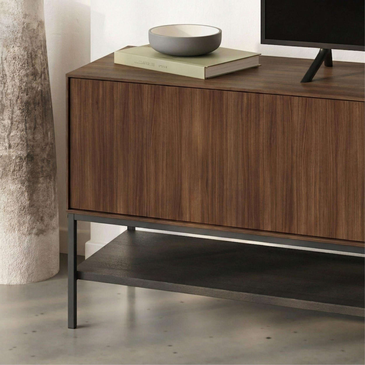 Amira TV unit corner view, light wood cabinet fronts and black open storage bay
