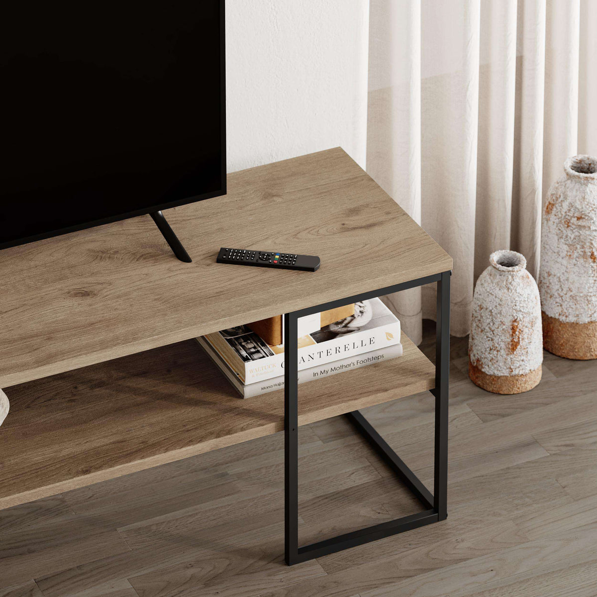 TV unit side close-up with open storage shelf, black frame and oak-toned top