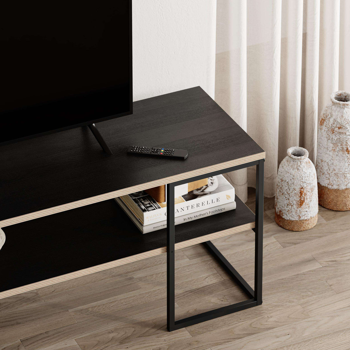 TV unit side close-up with open shelf, dark tabletop, and black frame