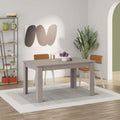 Light mocha extendable dining table with rectangular top and four tapered legs.