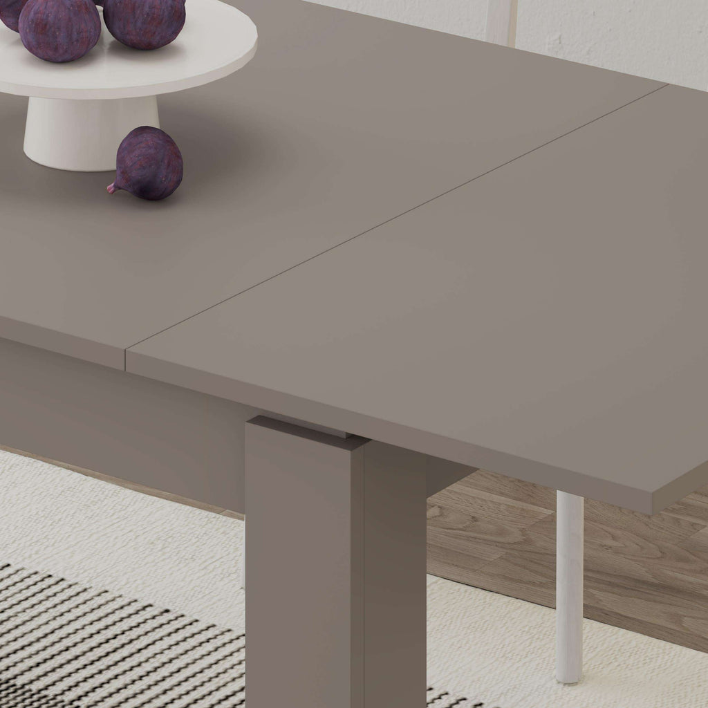 Light mocha dining table side close-up with smooth tabletop and tapered legs