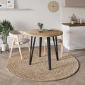 Round dining table with natural oak top and black tapered legs