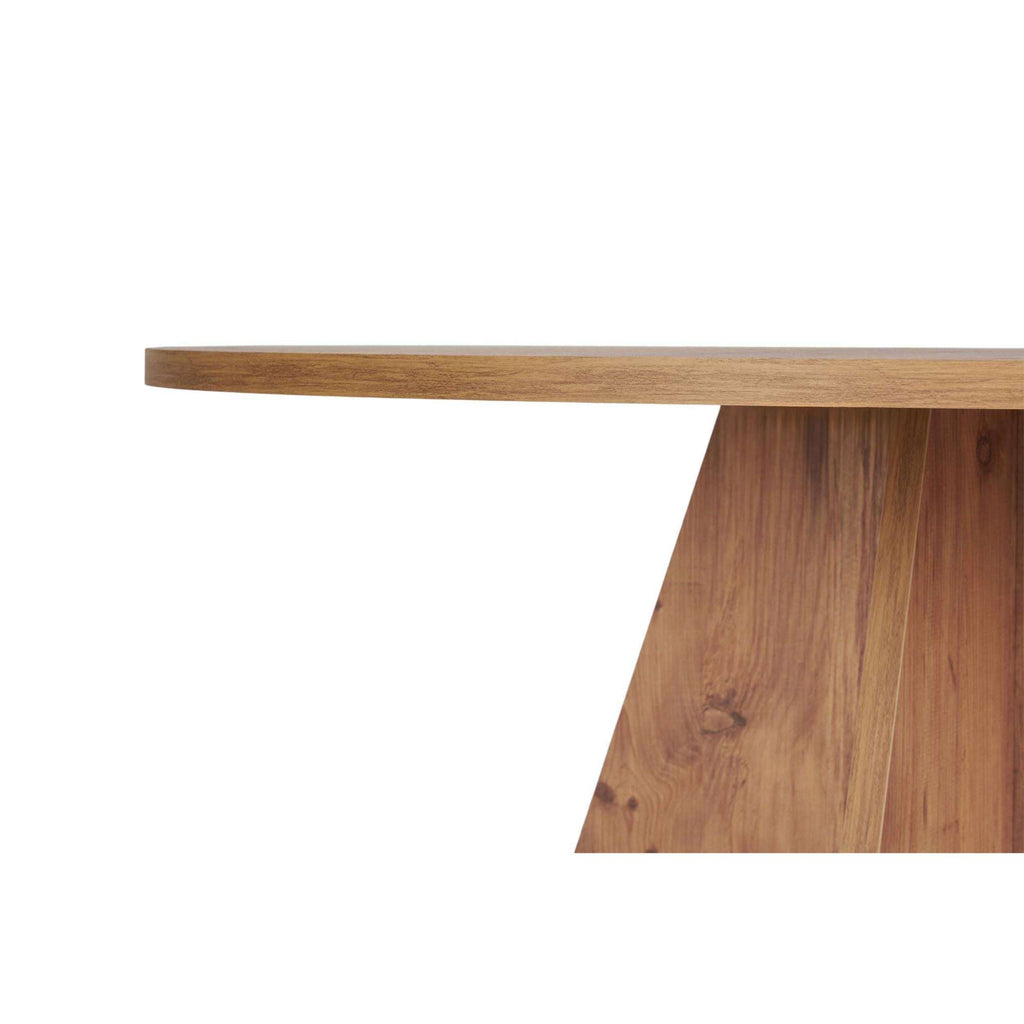 Side view of round dining table showing thick tabletop and tapered pedestal base
