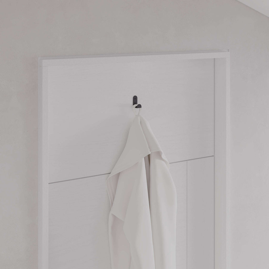 Black metal wall hanger hook set of 3 holding folded white towels on a door