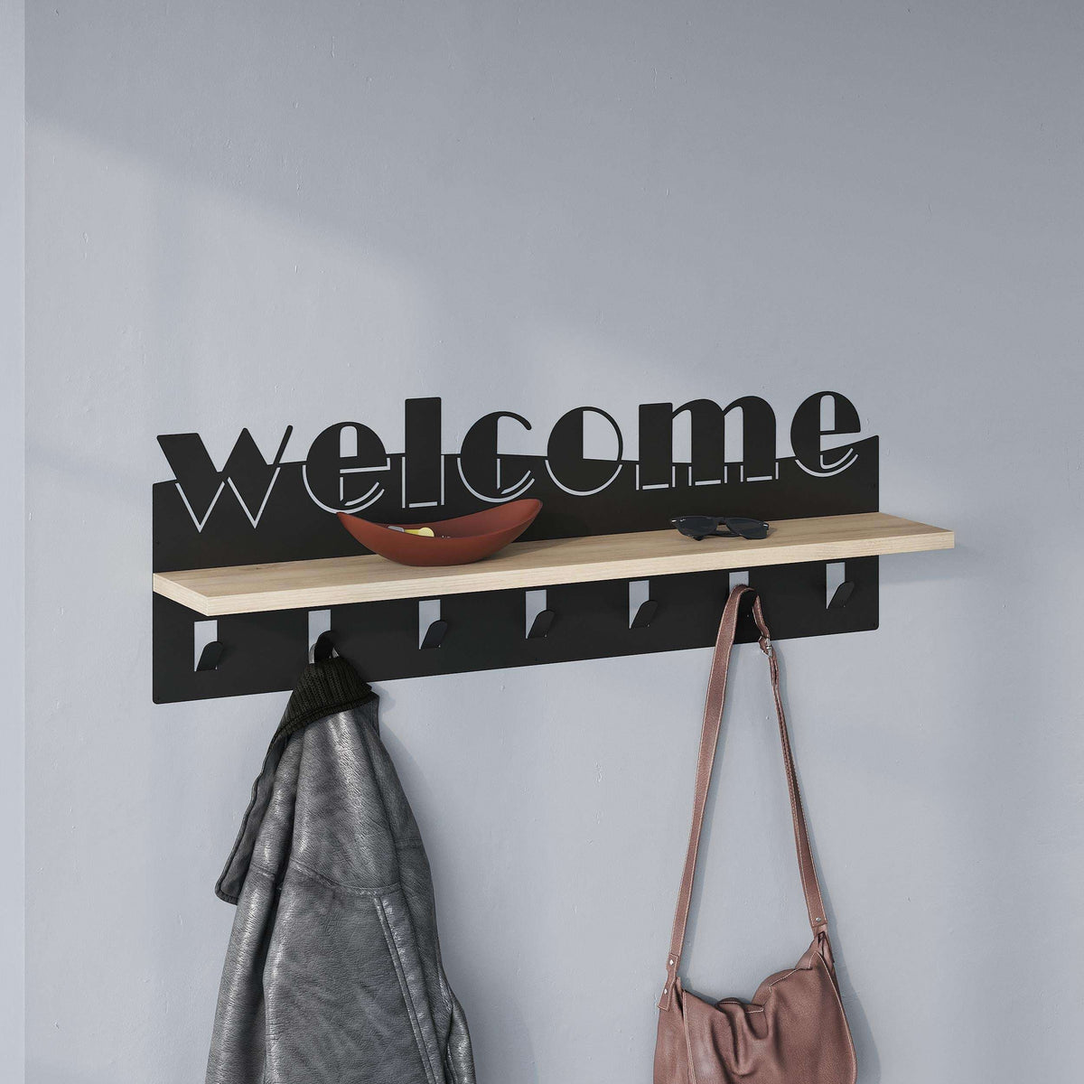 Wood-and-black coat hanger rack with hooks and hanging coat and handbag