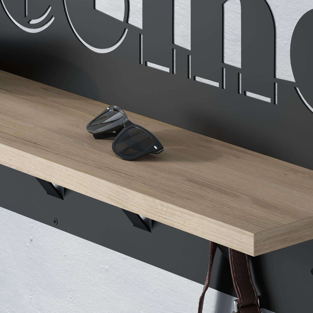 Close-up of wood top and black hooks on a coat hanger rack
