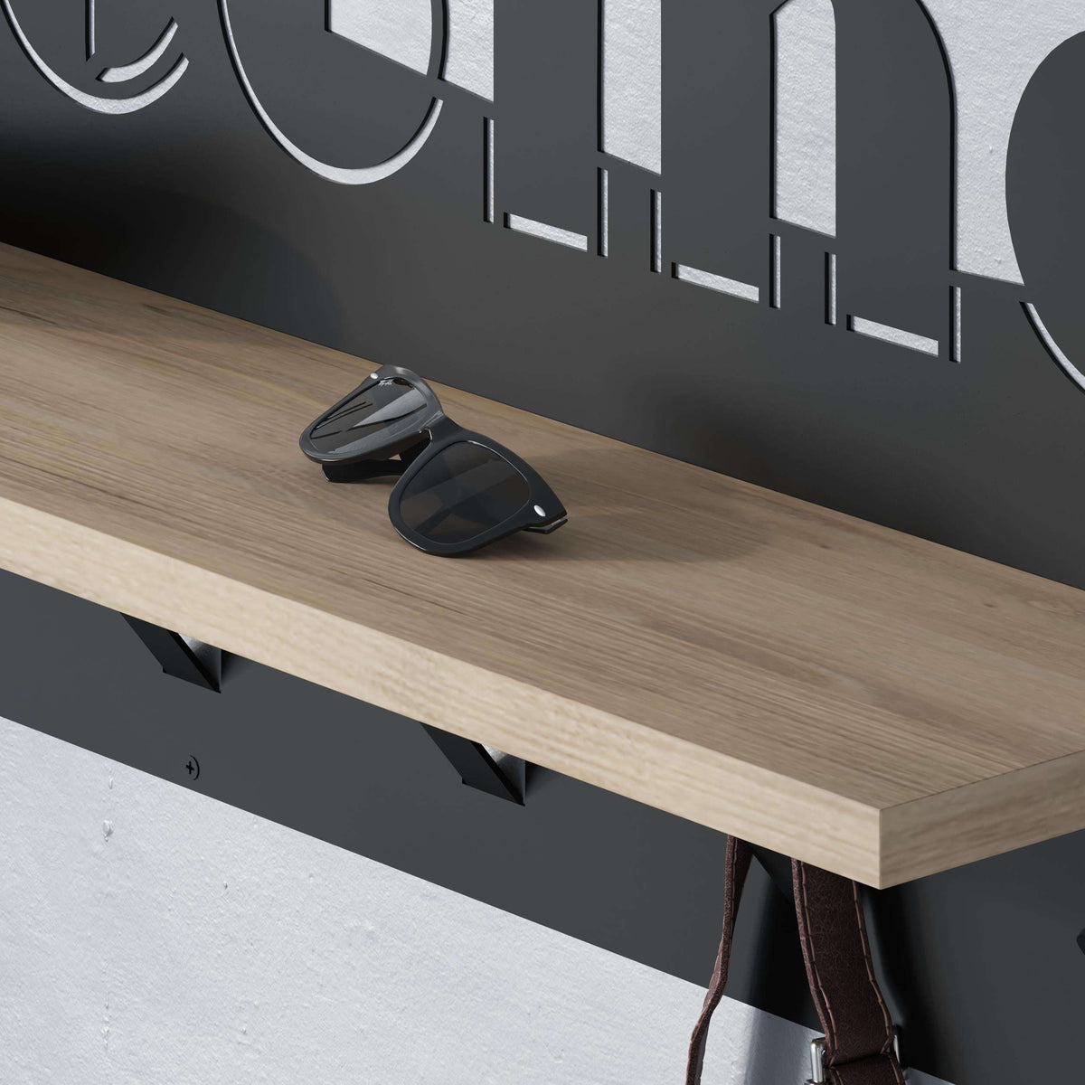 Close-up of wood top and black hooks on a coat hanger rack
