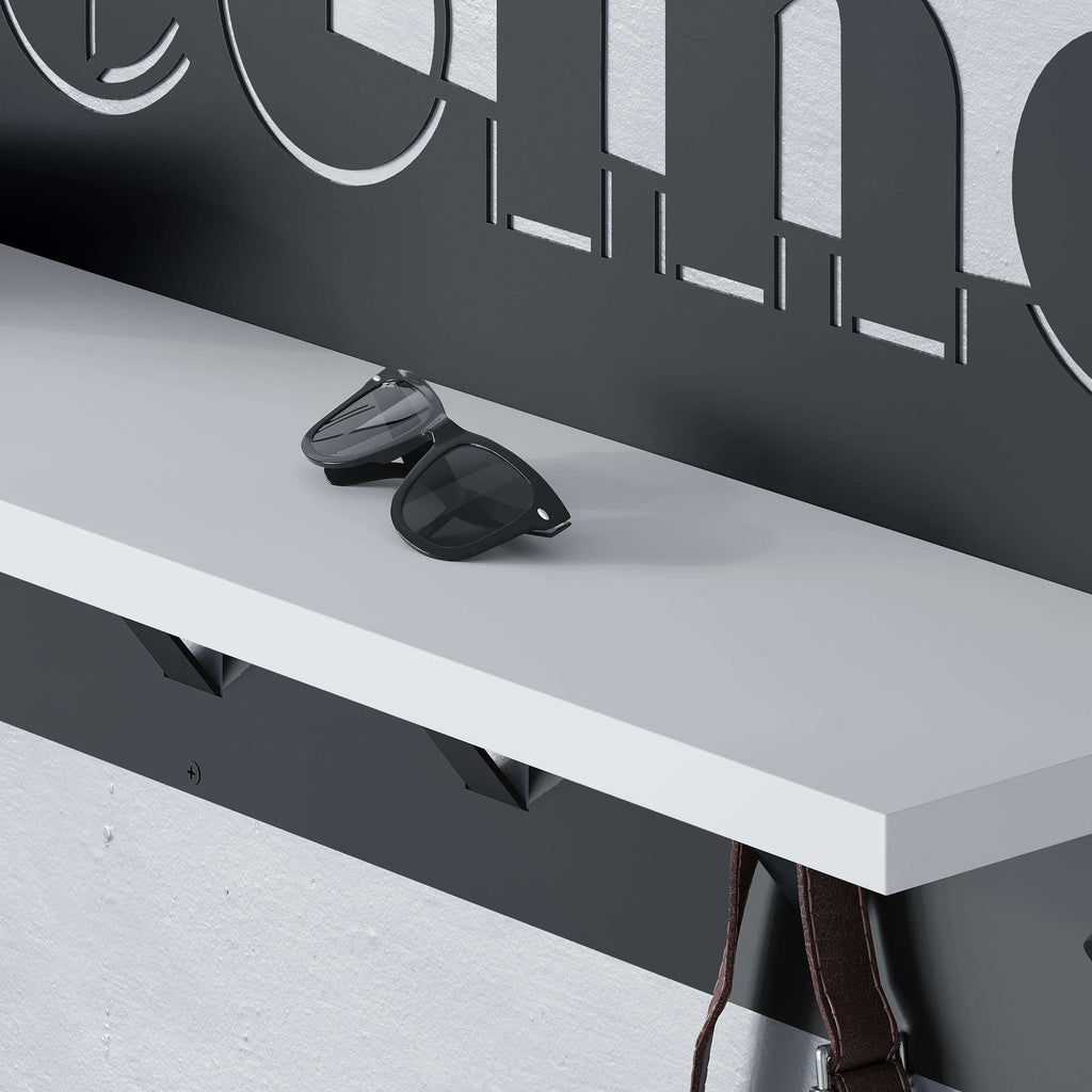 Wall-mounted coat hanger rack with hooks and shelf, close-up