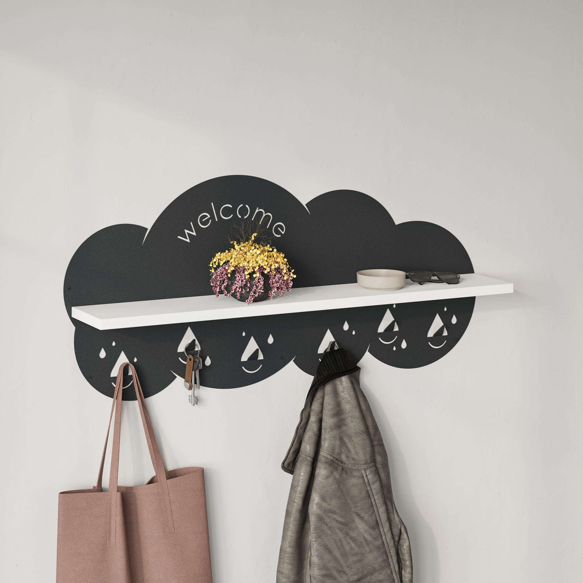 Wall-mounted cloud coat rack with white shelf, “welcome” sign, and bag and jacket