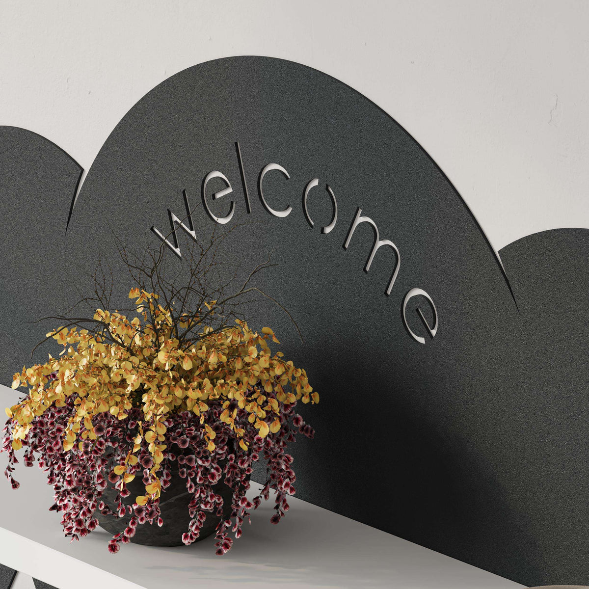 Close-up of cloud top with raised “welcome” lettering on wall hanger shelf