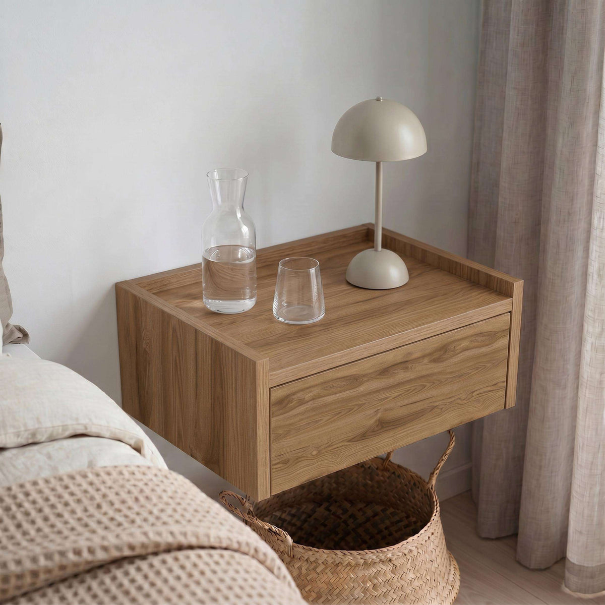 Floating bedside table with drawer and top shelf, warm wood with light top surface