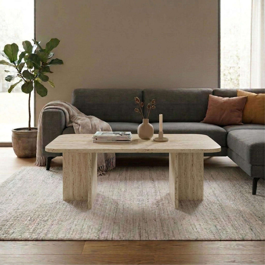 Rectangular coffee table with textured travertine-look top and tapered wooden legs