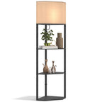 Tall corner floor lamp with black frame, beige fabric shade, and multi-tier shelves