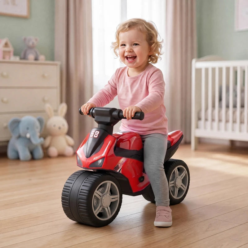 Red and black toddler balance bike with front fairing, wide tires, and grippy handlebars