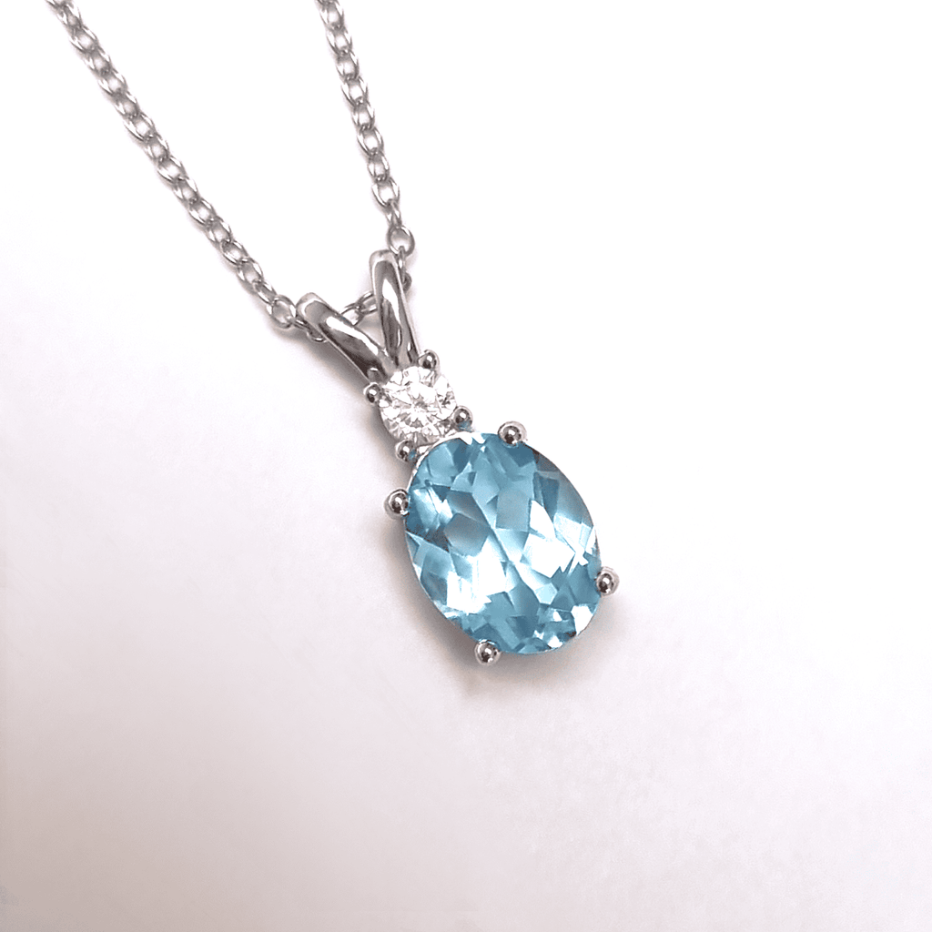 Blue topaz pendant necklace in sterling silver with oval faceted gemstone
