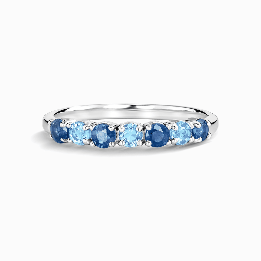 Sterling silver half-eternity ring with oval blue gemstones in channel setting