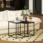 Black nesting coffee tables with tempered glass tops and metal frames on a rug