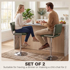 Two green PU leather bar stools with backrests, chrome bases, adjustable seat height