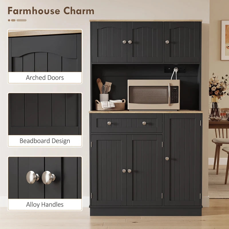 Black kitchen cupboard with arched cabinet doors, drawer, and open microwave counter area