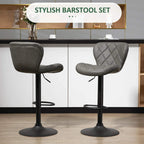 Pair of dark grey bar stools with diamond tufted backrests, swivel seats, metal footrests