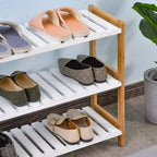 Natural wood 3-tier shoe rack with white slatted shelves holding multiple shoes