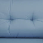 Blue upholstered outdoor sofa cushion with tufted, padded seat surface detail