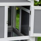 Grey rabbit hutch side door open to a dark interior access compartment
