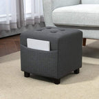 Grey square ottoman with side pocket storage, padded seat, and dark wooden legs