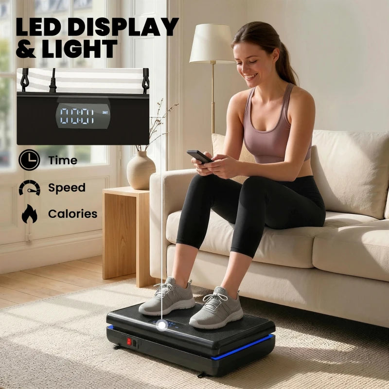 Black vibration plate exercise machine with LED display light while seated person holds controls