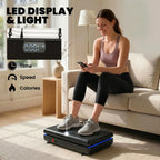 Black vibration plate exercise machine with LED display light while seated person holds controls
