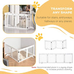 White pet gate folded in a corner layout with vertical bars and paw-print top rail